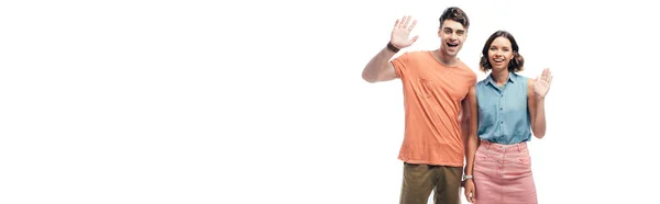 Panoramic shot of cheerful man and woman waving hands and looking at camera isolated on white — Stock Photo