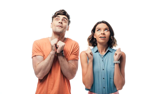 Esperando que el hombre y la mujer mirando hacia arriba y mostrando por favor gestos aislados en blanco - foto de stock