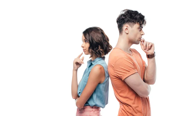 Displeased man and woman standing back to back and holding hands near faces isolated on white — Stock Photo