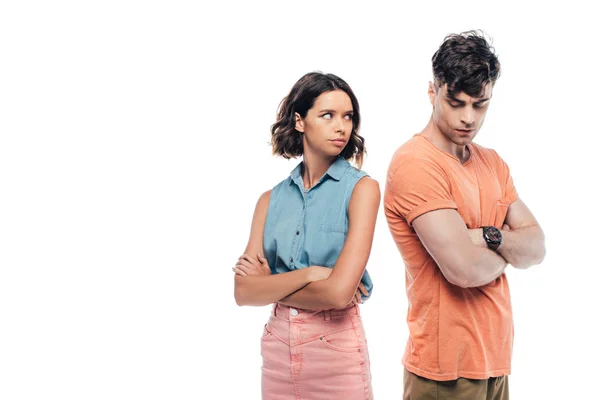 Ofendido joven pareja de pie con los brazos cruzados aislados en blanco - foto de stock