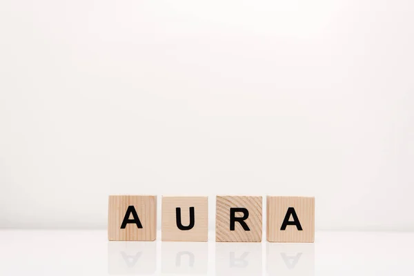 Word aura lettering on wooden blocks on white — Stock Photo