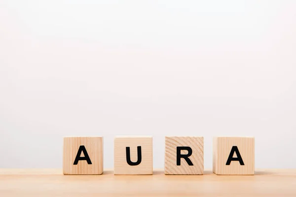 Word aura lettering on wooden blocks on white — Stock Photo