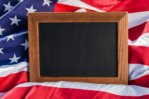 Blank chalkboard on american flag with stars and stripes — Stock Photo
