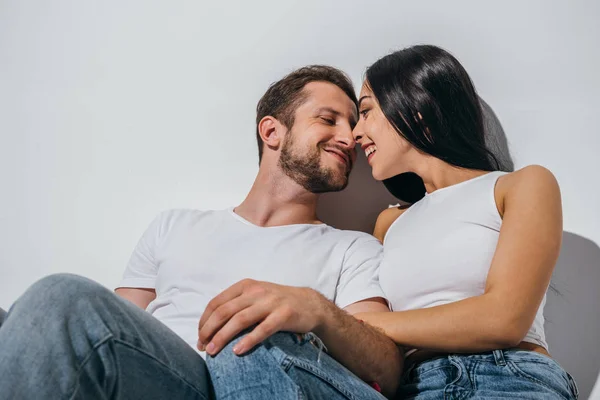 Couple amoureux assis sur le sol, souriant et se regardant — Photo de stock