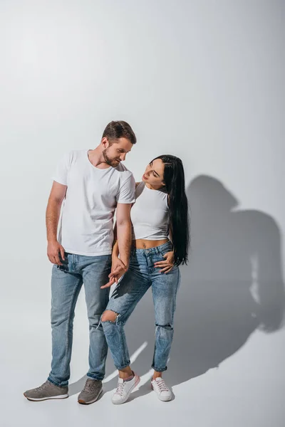 Full length view young people in love holding hands and looking at each other — Stock Photo