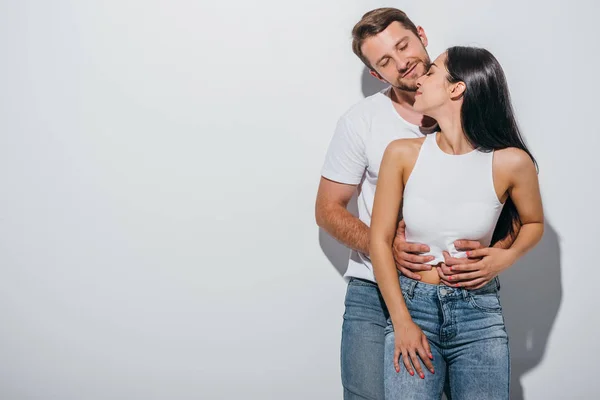 Young couple in love hugging each other with closed eyes — Stock Photo