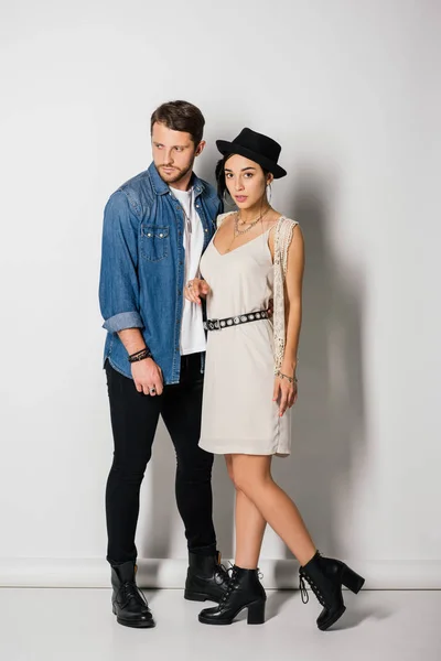 Full length view of young couple in stylish clothes standing close to each other — Stock Photo