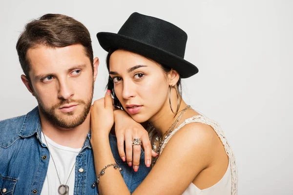 Beautiful girl leaning on handsome guy and looking at camera — Stock Photo