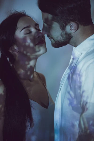 Cute couple standing in darkness close to each other — Stock Photo