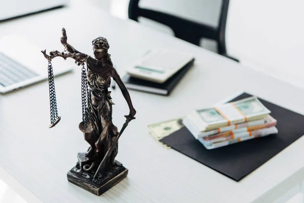 Selective focus of statuette of justice near money on wooden table — Stock Photo