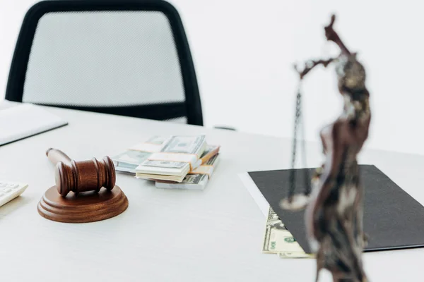 Selective focus of money near gavel of judge and statuette of justice — Stock Photo