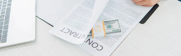 Panoramic shot of man near contract and money on table — Stock Photo