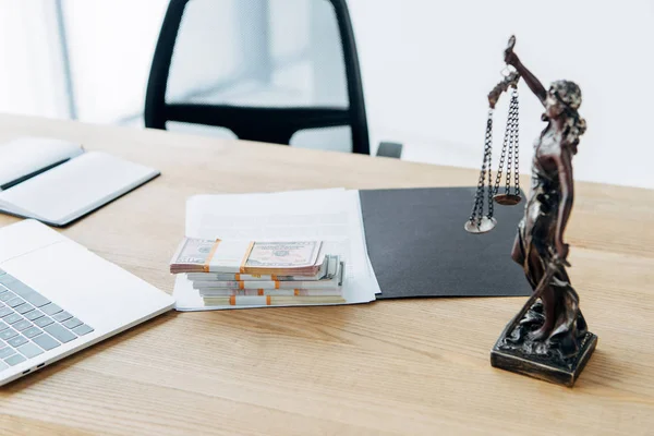 Selective focus of money on folder with documents near statuette of justice — Stock Photo
