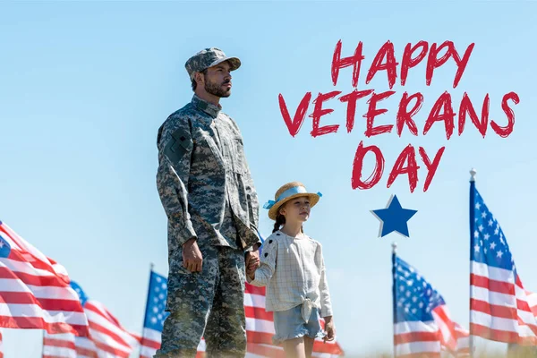 Cute kid holding hands with military father near american flags with happy veterans day illustration — Stock Photo