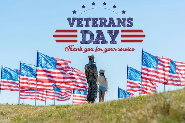 Man in military uniform standing with daughter near american flags with veterans day, thank you for your service illustration — Stock Photo