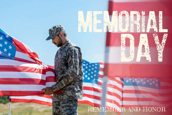 Selective focus of man in military uniform and cap standing and touching american flag  with memorial day, remember and honor illustration — Stock Photo