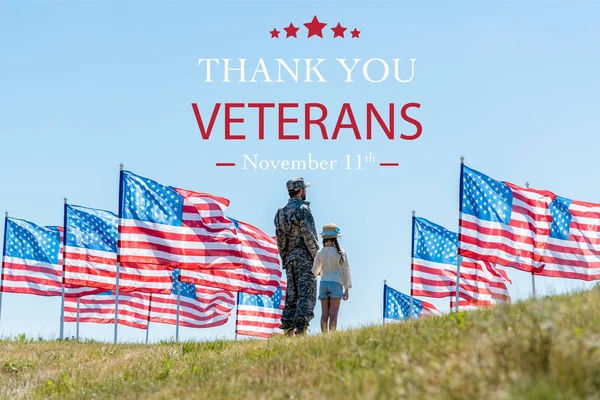 Man in military uniform standing with daughter near american flags  with thank you veterans illustration — Stock Photo