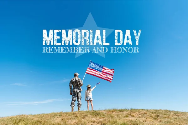 Back view of kid in straw hat and military father holding american flags  with memorial day, remember and honor illustration — Stock Photo