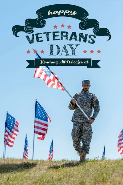 Handsome soldier in military uniform and cap holding american flag with happy veterans day, honoring all who served illustration — Stock Photo