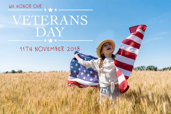 Cheerful child in straw hat holding american flag in golden field with wheat with veterans day illustration — Stock Photo