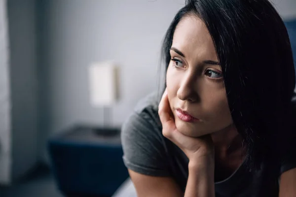 Selective focus of beautiful depressed woman looking away at home — Stock Photo
