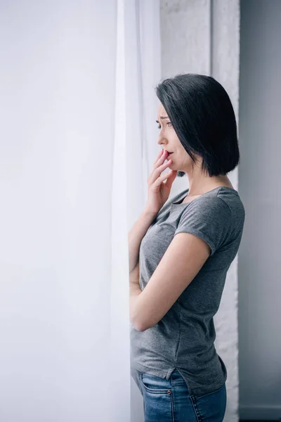 Красивая расстроенная женщина закрывает рот дома с копировальным пространством — стоковое фото
