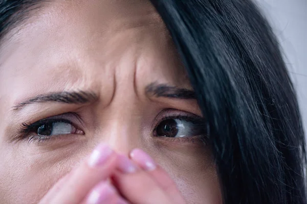 Close up view of beautiful depressed woman covering mouth at home — Stock Photo