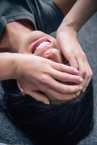 Depressed brunette woman covering face with hands and crying at home — Stock Photo