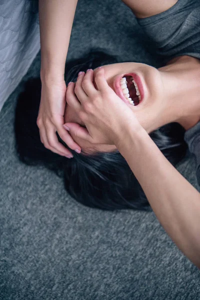 Depressed lonely brunette woman covering face with hands and crying at home — Stock Photo