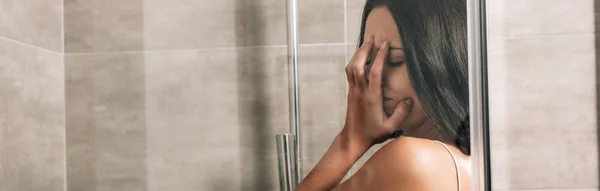 Panoramic shot of lonely depressed woman crying in shower at home — Stock Photo