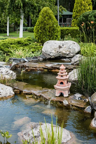 Clean water flowing on rocks near bushes and trees — Stock Photo