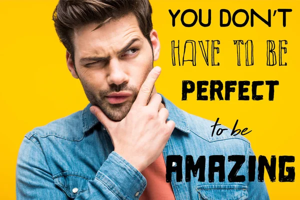 Thoughtful handsome man touching chin isolated on yellow with you dont have to be perfect to be amazing inspiration — Stock Photo