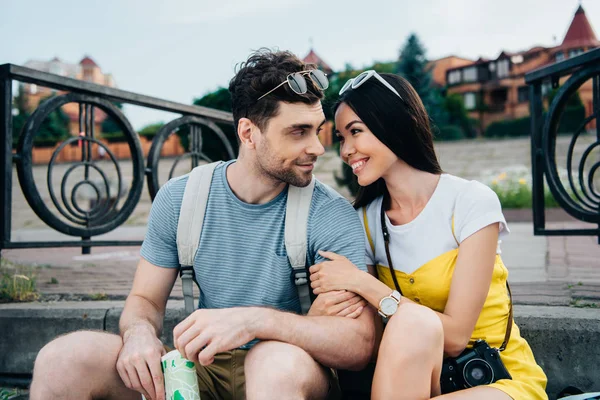 Asian woman and handsome man hugging and looking at each other — Stock Photo