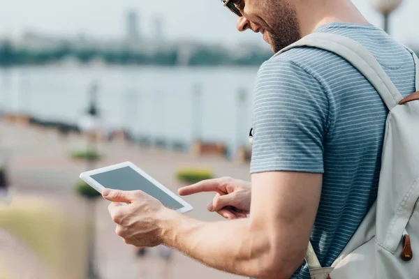 Cropped view of man in glasses with backpack using digital tablet — Stock Photo