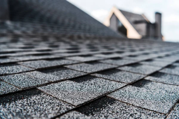 Selective focus of grey shingles on rooftop of building — Stock Photo