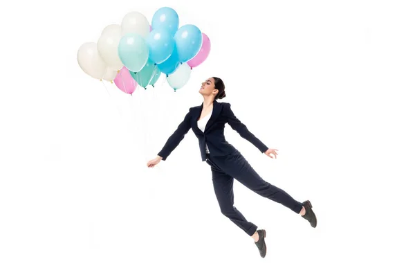 Feliz mujer de negocios en ropa formal levitando con globos festivos aislados en blanco - foto de stock