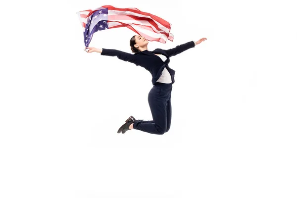 Young businesswoman jumping in dance while holding usa national flag isolated on white — Stock Photo