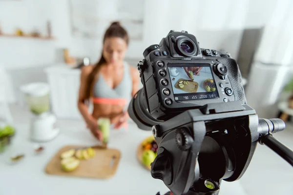 Selective focus of digital camera with girl holding smoothie on screen — Stock Photo