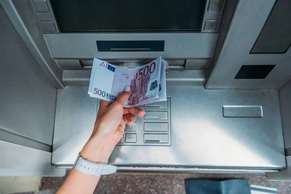 Top view of woman taking money from atm machine — Stock Photo