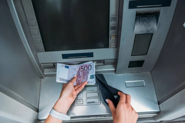 Frau mit Geld und schwarzer Brieftasche in der Nähe des Geldautomaten — Stockfoto