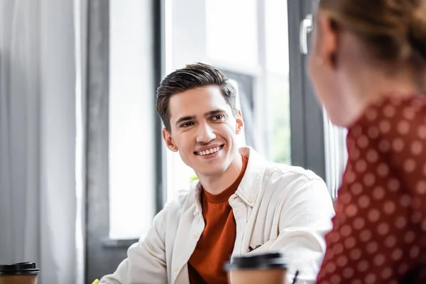 Selective focus of smiling student looking at his friend — Stock Photo