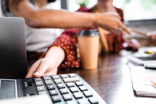 Selective focus of student taking calculator on table in apartment — Stock Photo