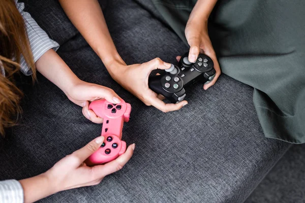 KYIV, UKRAINE - JULY 10, 2019: cropped view of multicultural friends playing video game in apartment — Stock Photo