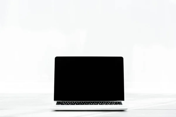 Laptop com tela em branco na mesa de madeira no branco — Fotografia de Stock