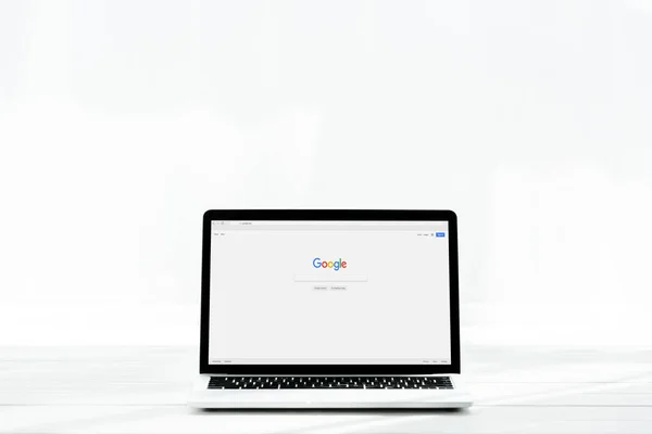 KYIV, UKRAINE - JULY 23, 2019: modern laptop with google website on screen on white — Stock Photo