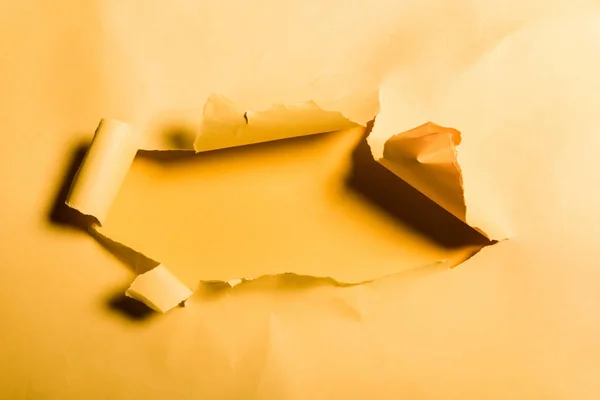 Tattered and textured paper with rolled edge on orange — Stock Photo