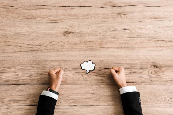 Vista superior de la mujer con los puños cerrados cerca de la nube de papel con trueno — Stock Photo