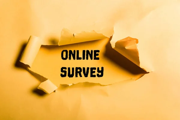 Tattered paper with online survey lettering and rolled edges on orange — Stock Photo