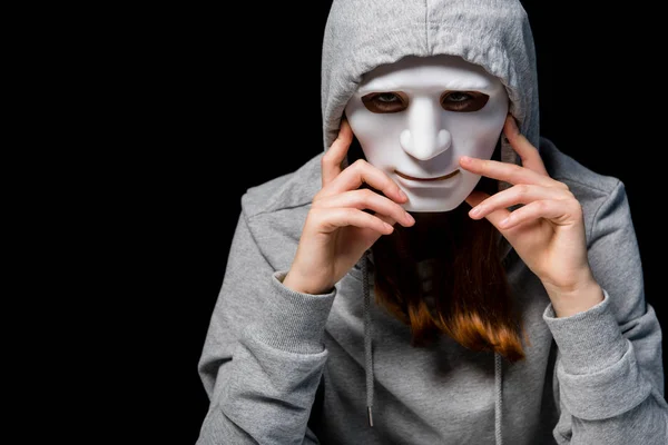 Anonymous girl in grey hoodie and mask isolated on black — Stock Photo
