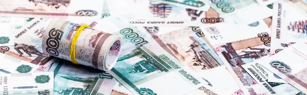 Panoramic shot of cash roll on russian money — Stock Photo